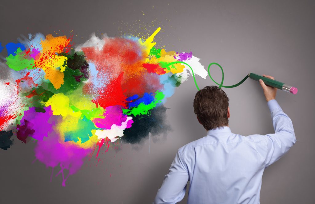 Businessman painting abstract colorful design on gray background concept for business creativity, i